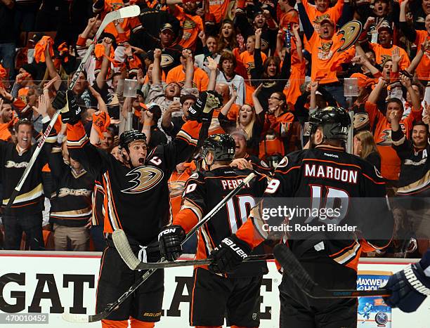 Ryan Getzlaf of the Anaheim Ducks reacts after scoring with teammates Corey Perry and Patrick Maroon against the Winnipeg Jets during the third...