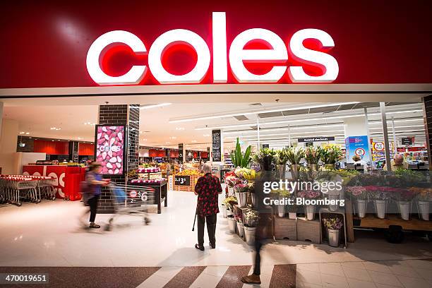 Shopper stands at the entrance to a Coles supermarket, operated by Wesfarmers Ltd., in Sydney, Australia, on Tuesday, Feb. 18, 2014. Wesfarmers,...