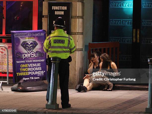 Police mingle amongst revellers as they walk and gather between the various pubs and clubs in Broad Street, the heartland of nightclubs and bars in...