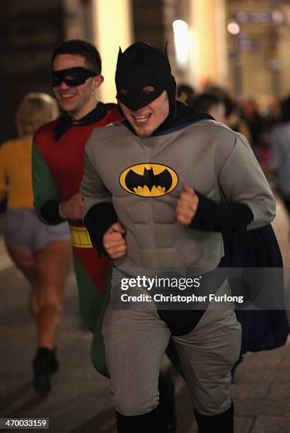 Revellers in fancy dress walk and gather between the various pubs and clubs in Broad Street, the heartland of nightclubs and bars in Birmingham City...