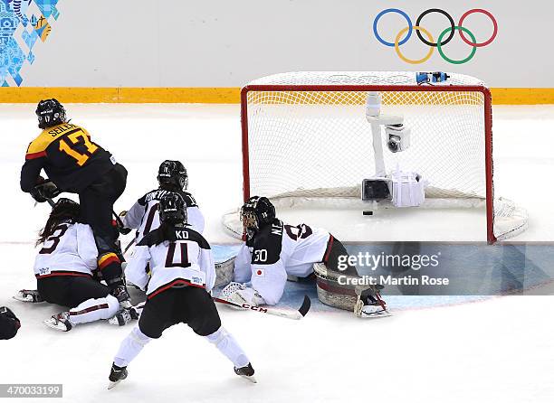 Sara Seiler of Germany shoots and scores against Nana Fujimoto of Japan in the second period during the Women's Classifications Game on day 11 of the...