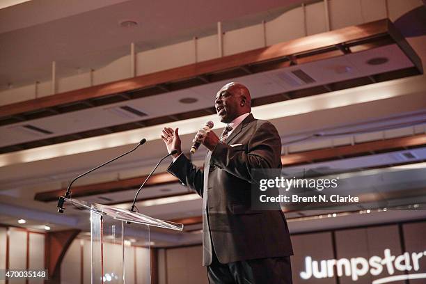 Former professional football player Ottis "OJ" Anderson conducts a live auction from the stage during the Scribbles To Novels 10th Anniversary Gala...