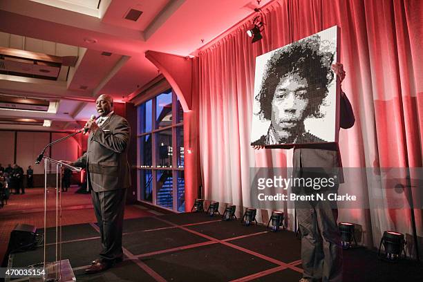 Former professional football player Ottis "OJ" Anderson conducts a live auction from the stage during the Scribbles To Novels 10th Anniversary Gala...
