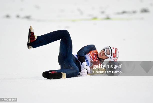 Taihei Kato of Japan crashes as he competes in the Nordic Combined Men's Individual LH during day 11 of the Sochi 2014 Winter Olympics at RusSki...