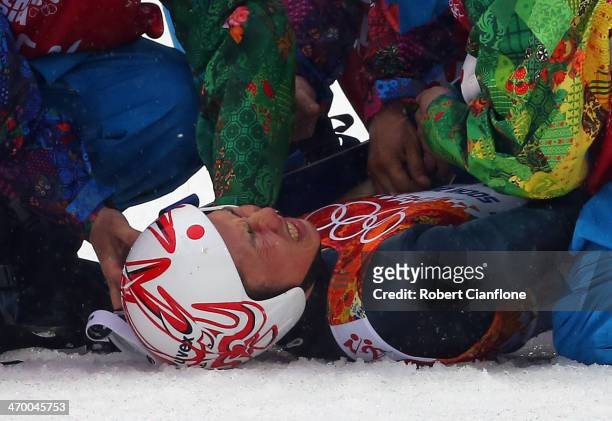 Taihei Kato of Japan is treated by medical staff after crashing during the Nordic Combined Men's Individual LH on day 10 of the Sochi 2014 Winter...