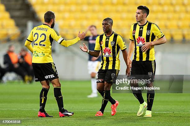 Andrew Durante of the Phoenix congratulates Roly Bonevacia on his goal while Michael Boxall looks on during the round 26 A-League match between the...