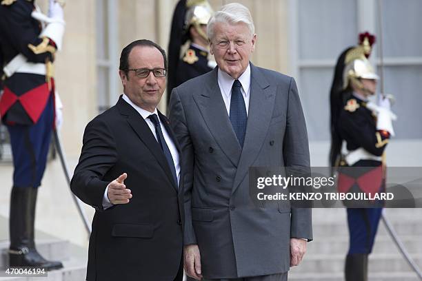 French President Francois Hollande welcomes Iceland President Olafur Ragnar Grimsson before a meeting at the Elysee Palace in Paris on April 17,...