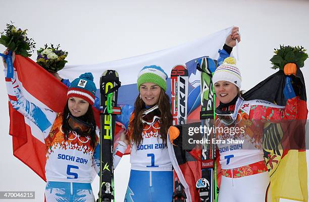 Silver medalist Anna Fenninger of Austria, gold medalist Tina Maze of Slovenia and bronze medalist Viktoria Rebensburg of Germany celebrate on the...