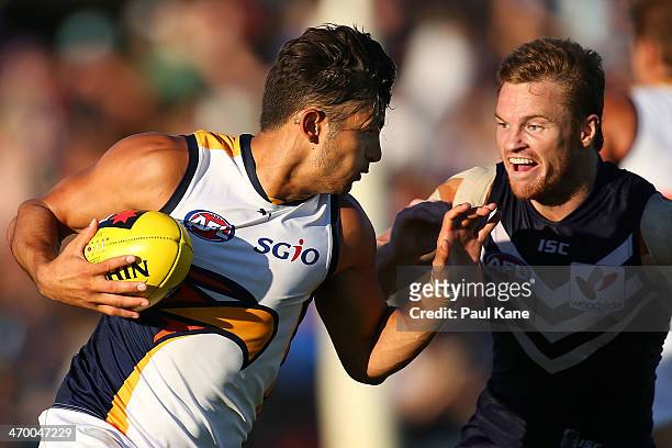 Sharrod Wellingham of the Eagles looks to avoid being tackled by Colin Sylvia of the Dockers during the round two NAB Challenge Cup AFL match between...