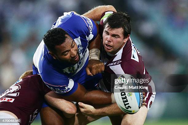 Tony Williams of the Bulldogs drops the ball in a tackle by Jamie Lyon of the Sea Eagles during the round seven NRL match between the Canterbury...