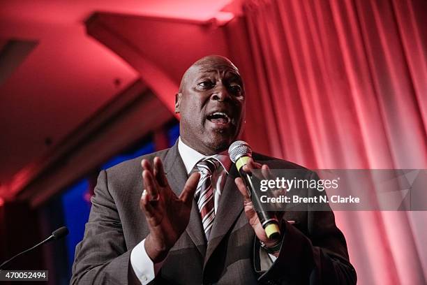 Former professional football player Ottis "OJ" Anderson conducts a live auction from the stage during the Scribbles To Novels 10th Anniversary Gala...