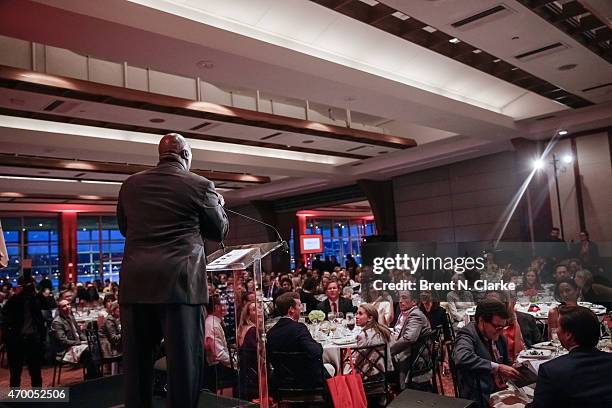 Former professional football player Ottis "OJ" Anderson conducts a live auction from the stage during the Scribbles To Novels 10th Anniversary Gala...