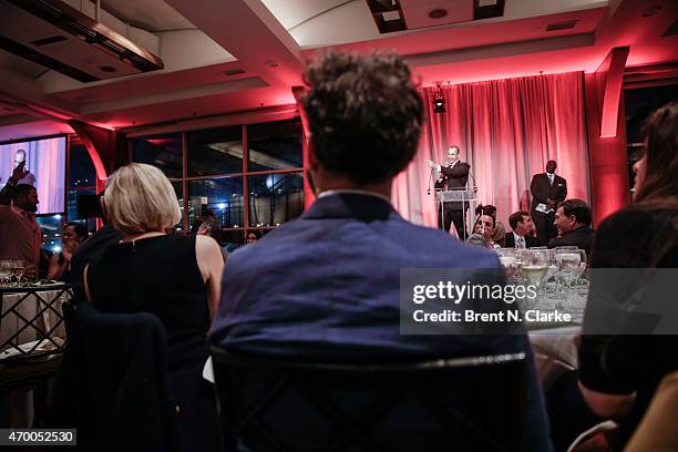 Photographer Nigel Barker conducts a live auction from the stage during the Scribbles To Novels 10th Anniversary Gala held at Pier Sixty at Chelsea...