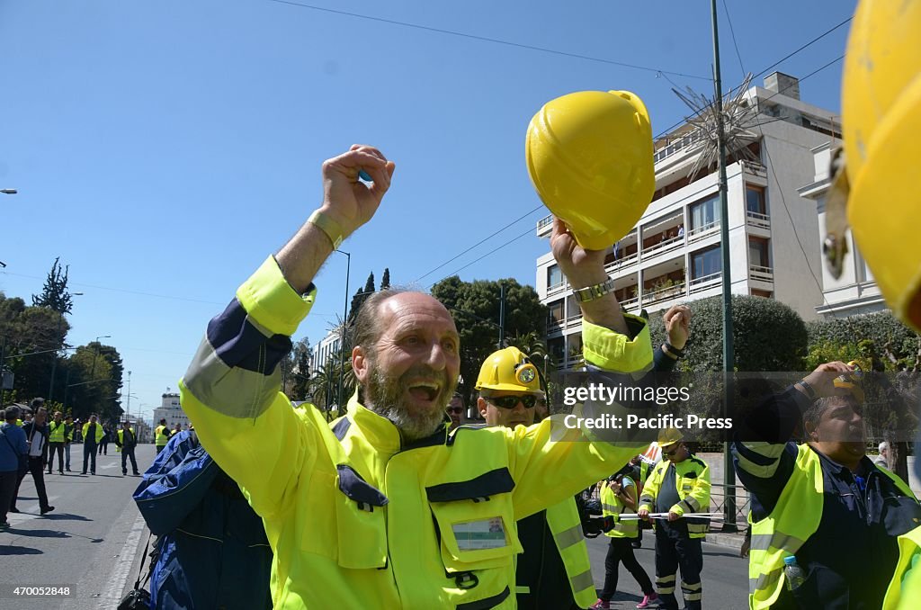 A demonstrator makes noise with his hardhat in protest.