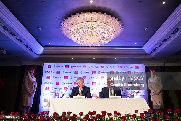 John Rishton, chief executive officer of Rolls-Royce Holdings Plc, center left, listens as Tim Clark, president of Emirates Airline, center right,...