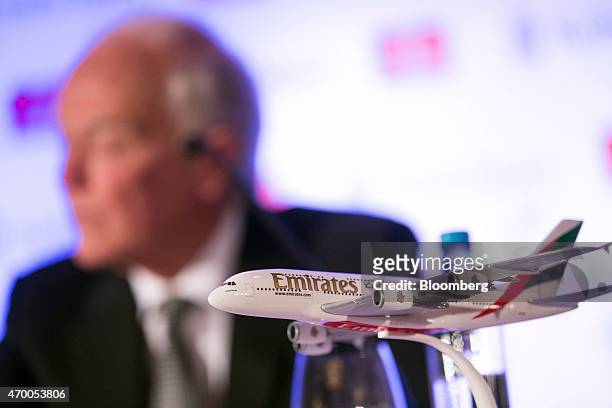 Tim Clark, president of Emirates Airline, sits behind a model of an Emirates branded Airbus Group NV A380 aircraft during a news conference in...