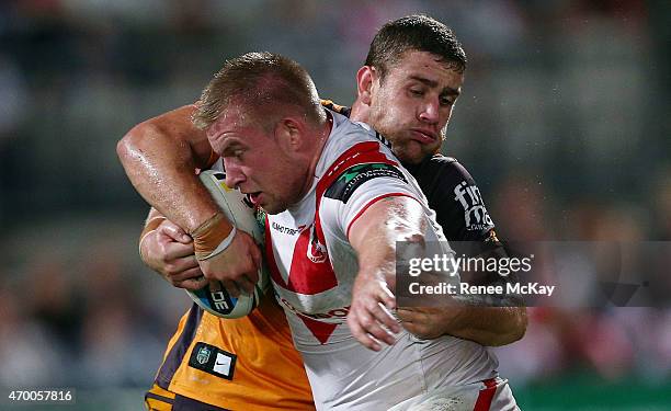 Mike Cooper of the Dragons is tackled by Andrew McCullough of the Broncos during the round seven NRL match between the St George Illawarra Dragons...