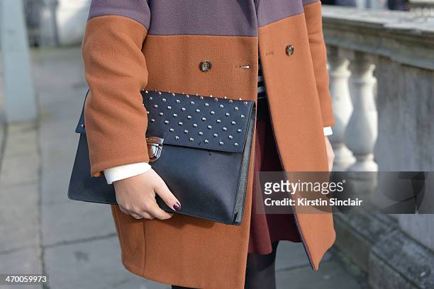 Editor in Chief of Suitcase Magazine Serena Guen wears a Missoni coat, Prada bag, Topshop sweater, Salvatore Ferragamo shirt on day 2 of London...