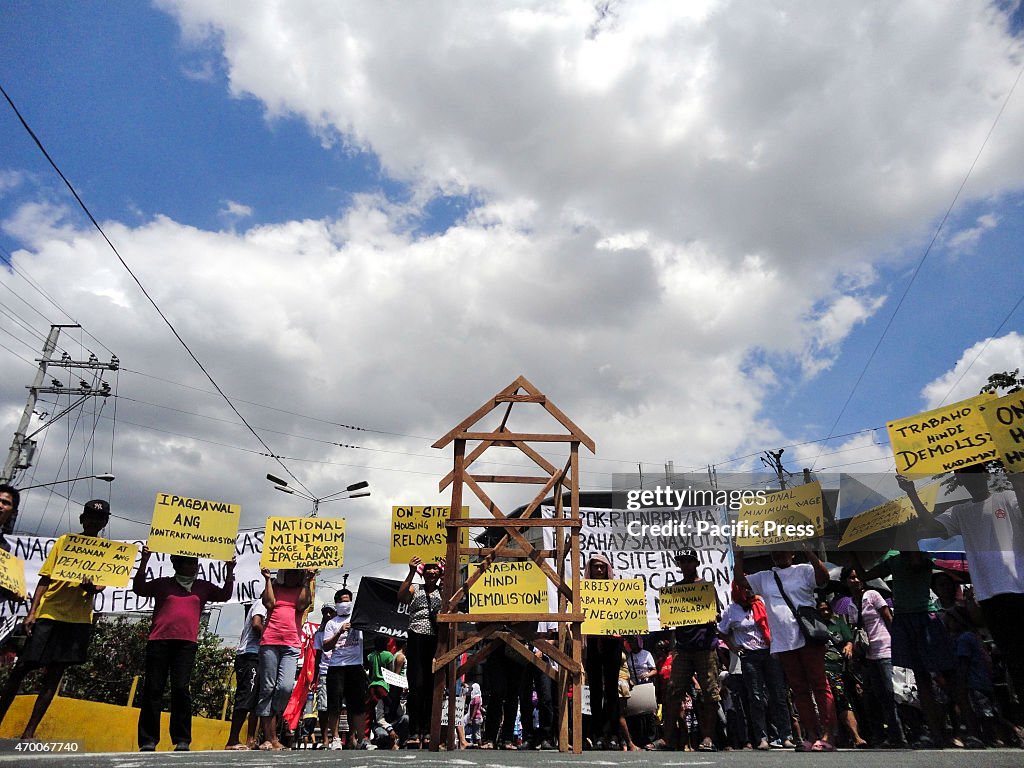 Filipino activists raise placards calling for decent housing...