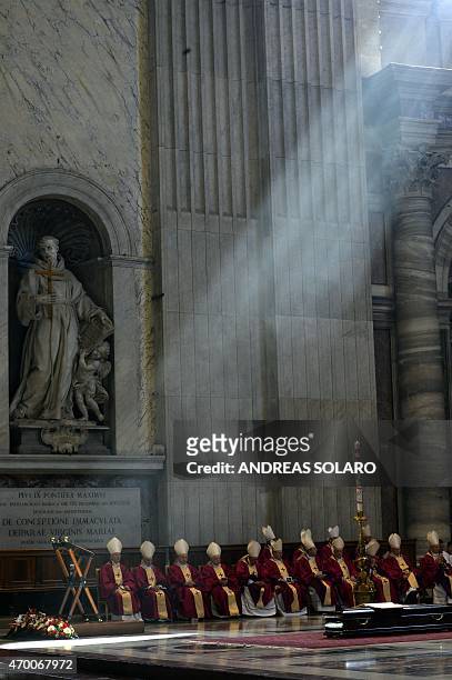 Cadinals sit in front of the coffin of Cardinal Roberto Tucci during his funeral at St Peter's basilica on April 17, 2015 at the Vatican. AFP PHOTO /...