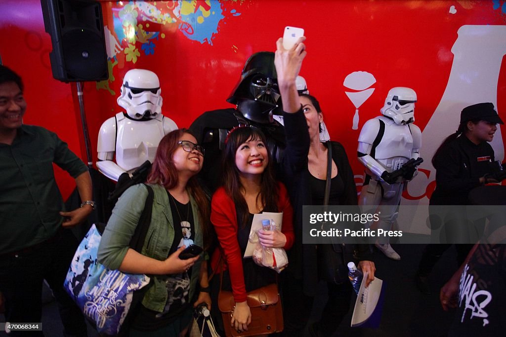 Star Wars fans take a selfie with Darth Vader during the...