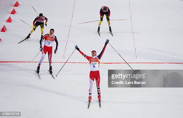 Joergen Graabak of Norway celebrates as he crosses the line to win the gold medal ahead of Magnus Hovdal Moan of Norway in the Nordic Combined Men's...