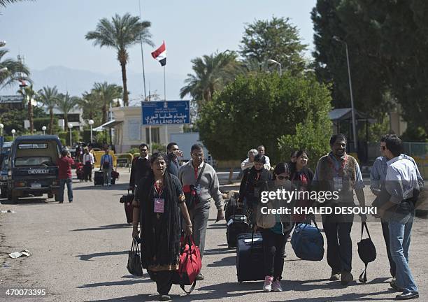 Tourists from India arrive in Egypt after crossing the Taba Land Port on February 18 two days after a tourist bus exploded in the Egyptian south...