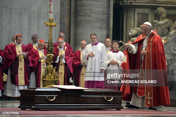 Pope Francis blesses the coffin of Cardinal Roberto Tucci during the funeral at St Peter's basilica on April 17, 2015 in Vatican. AFP PHOTO / ANDREAS...