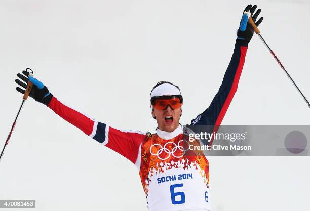 Joergen Graabak of Norway celebrates as he crosses the line to win the gold medal in the Nordic Combined Men's 10km Cross Country during day 11 of...