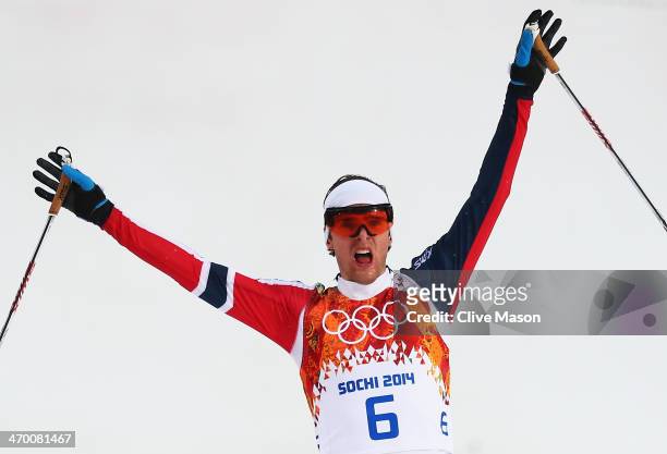 Joergen Graabak of Norway celebrates as he wins the gold medal in the Nordic Combined Men's 10km Cross Country during day 11 of the Sochi 2014 Winter...