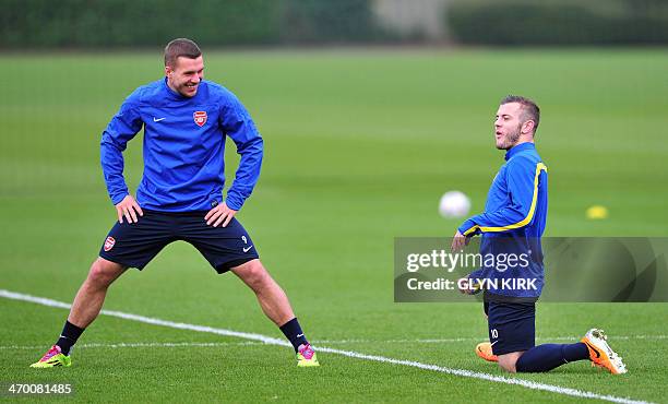 Arsenal's Polish-born German striker Lukas Podolski and Arsenal's English midfielder Jack Wilshere share a joke during a training session at...