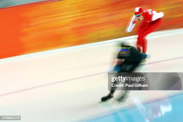 Sebastian Druszkiewicz of Poland and Patrick Meek of the United States compete during the Men's 10000m Speed Skating event on day eleven of the Sochi...