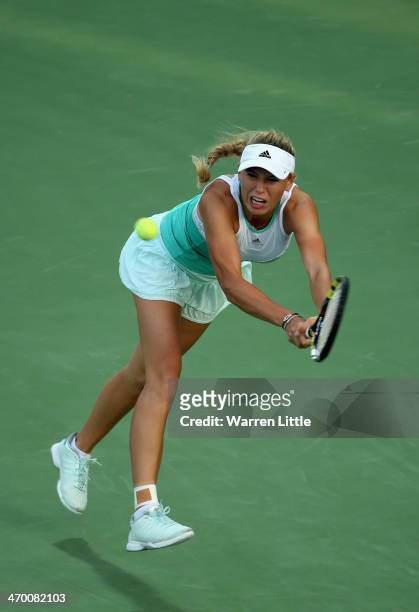Caroline Wozniacki of Denmark in action against Sabine Lisicki of Germany during day two of the WTA Dubai Duty Free Tennis Championship at the Dubai...
