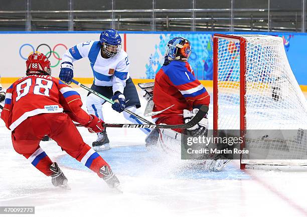 Michelle Karvinen of Finland shoots and scores against Anna Prugova of Russia in the third periodduring the Women's Classifications Game on day 11 of...