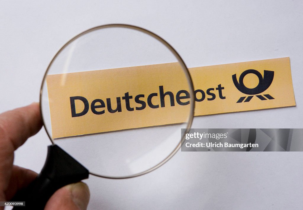 Magnifying glass with logo German Post AG.