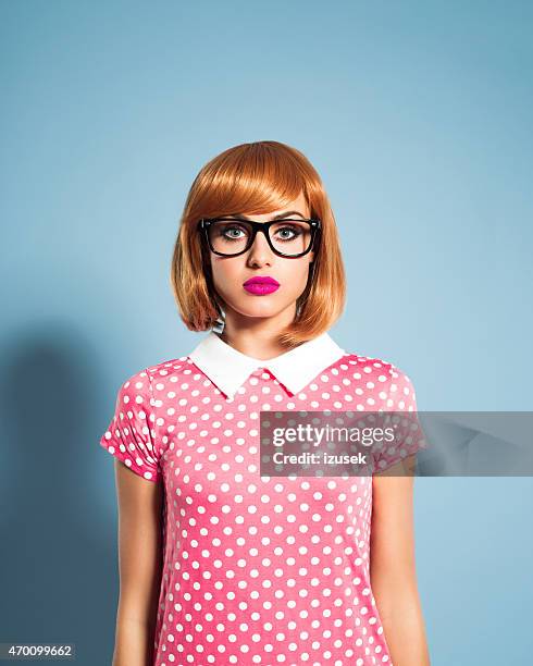 beautiful red hair young woman wearing polka dot dress - 1950 2015 stock pictures, royalty-free photos & images