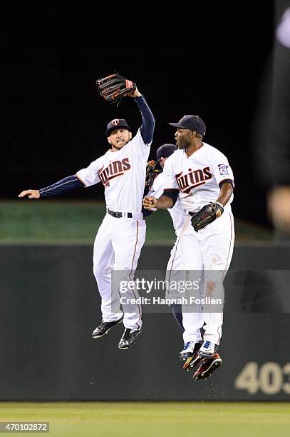 Shane Robinson, Jordan Schafer and Torii Hunter of the Minnesota Twins celebrate a win of the game against the Kansas City Royals on April 15, 2015...