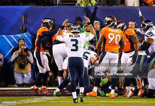 Quarterback Russell Wilson of the Seattle Seahawks celebrates aftering running back Marshawn Lynch scored a one yard touchdown during the second...
