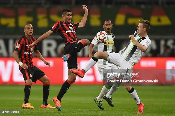 Slobodan Medojevic of Eintracht Frankfurt is challenged by Patrick Herrmann of Borussia Moenchengladbach during the Bundesliga match between...