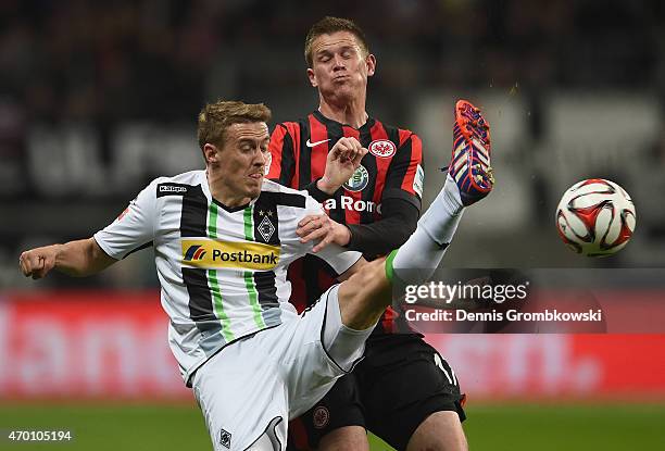 Max Kruse of Borussia Moenchengladbach is challenged by Alexander Madlung of Eintracht Frankfurt during the Bundesliga match between Eintracht...