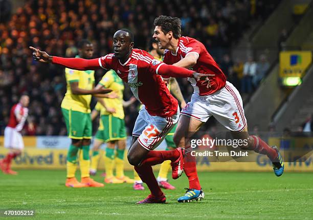 Albert Adomah and George Friend of Middlesbrough celebrate as Alexander Tettey of Norwich City scores their first goal with an own goal during the...