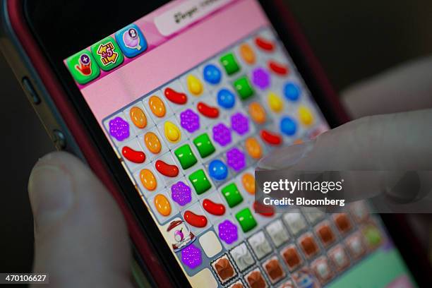 User plays the "Candy Crush Saga" puzzle game on an Apple.Inc iPhone 5 in this arranged photograph in London, U.K., on Tuesday, Feb. 18, 2014. King...