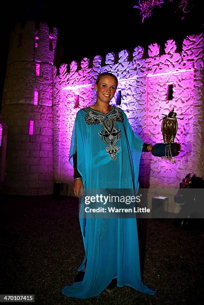 Caroline Wozniacki of Denmark poses for a picture in traditional dress and with a falcon during the players party during day two of the WTA Dubai...