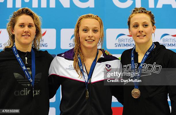 Jemma Lowe, Rachel Kelly and Sionhan-Marie O'Connor pose on the medal podium after the Womens Open 100m Butterfly Final during day four of the...