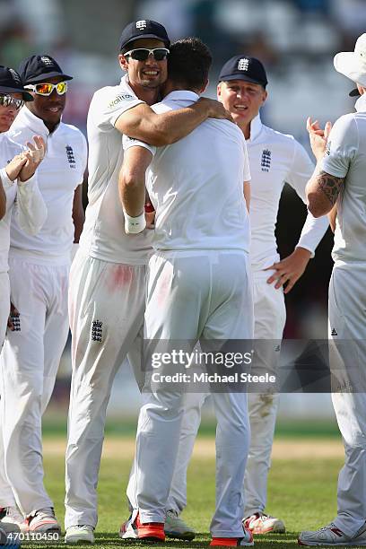 James Anderson of England is congratulated by Alastair Cook after taking the wicket of Denesh Ramdin of West Indies to pass Ian Botham's record of...