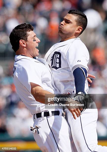 Jose Iglesias of the Detroit Tigers, right, chest-bumps Ian Kinsler of the Detroit Tigers after hitting an RBI-single to defeated the Chicago White...