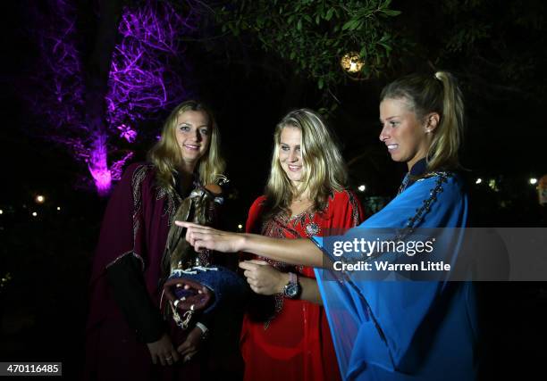 Czech players, Petra Kvitova, Lucie Safarova and Andrea Hlavackova pose with a falcon dressed in tradiional local dress during the players party on...