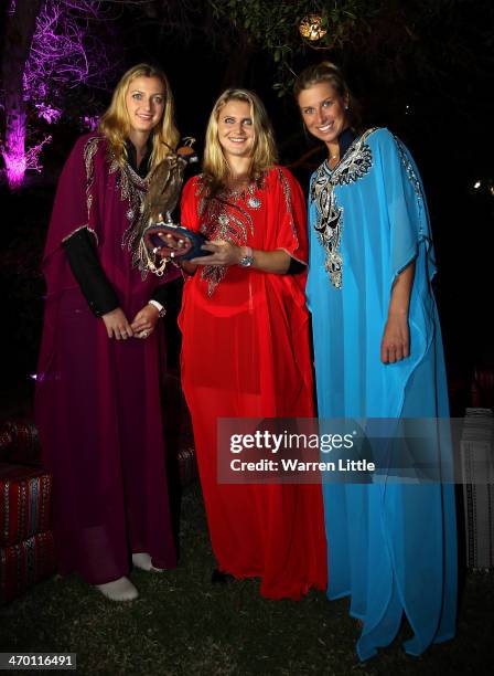 Czech players, Petra Kvitova, Lucie Safarova and Andrea Hlavackova pose with a falcon dressed in tradiional local dress during the players party on...