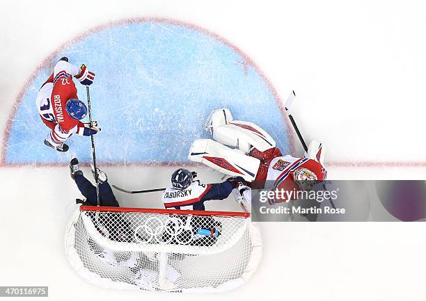 Andrej Meszaros and Tomas Zaborksy of Slovakia crash into the net of Ondrej Pavelec of Czech Republic in the first period during the Men's...