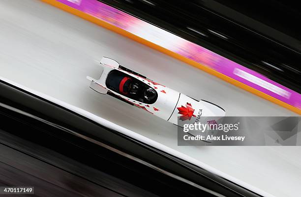 Kaillie Humphries and Heather Moyse of Canada team 1 make a run during the Women's Bobsleigh heats on day 11 of the Sochi 2014 Winter Olympics at...